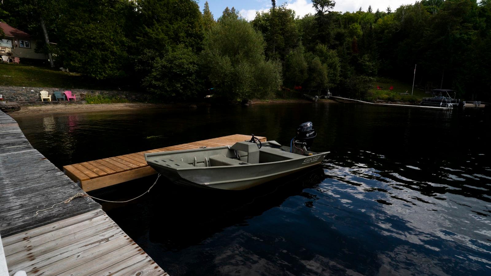 A boat tied up at a private lake dock