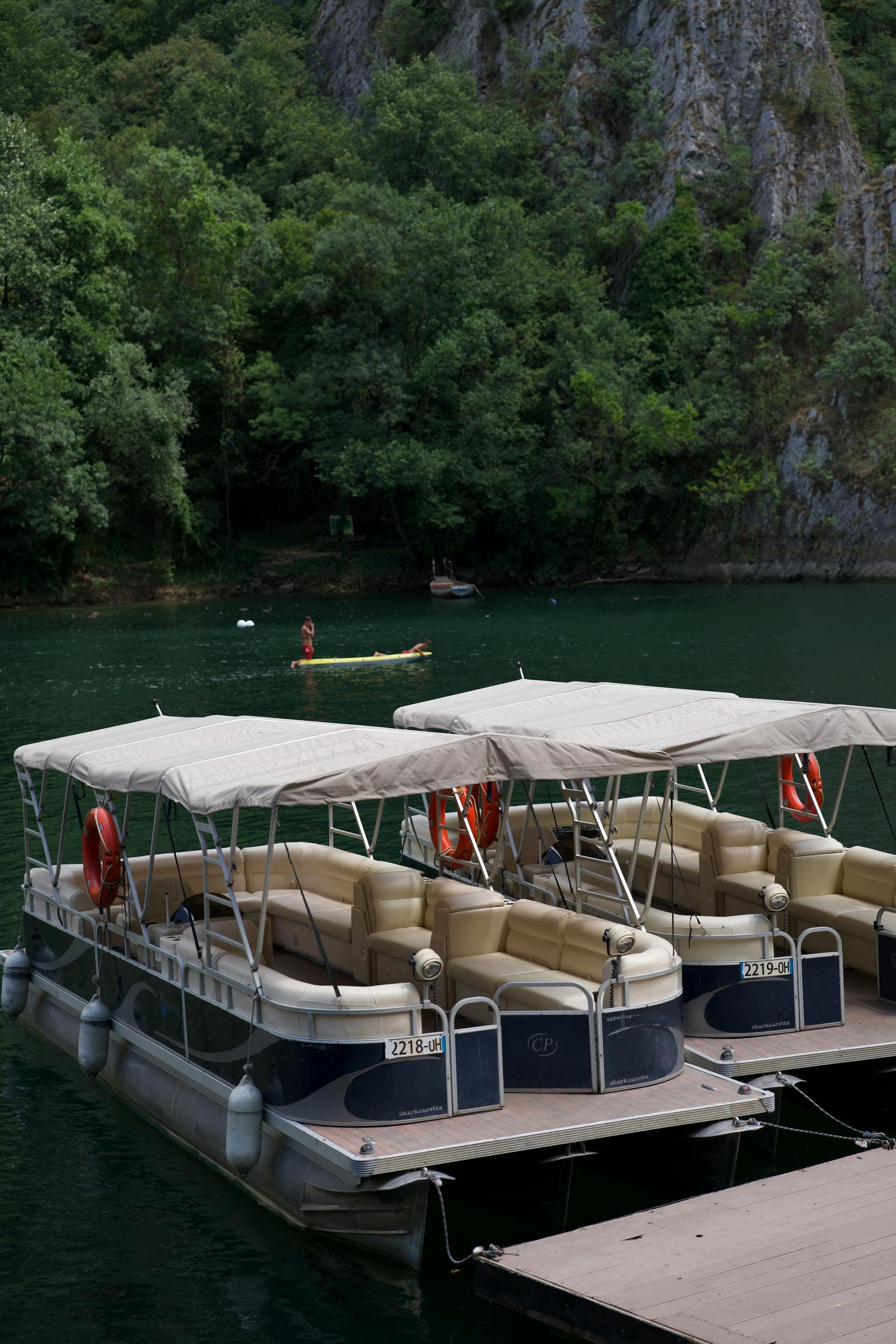 Two pontoons docked on a forest lake